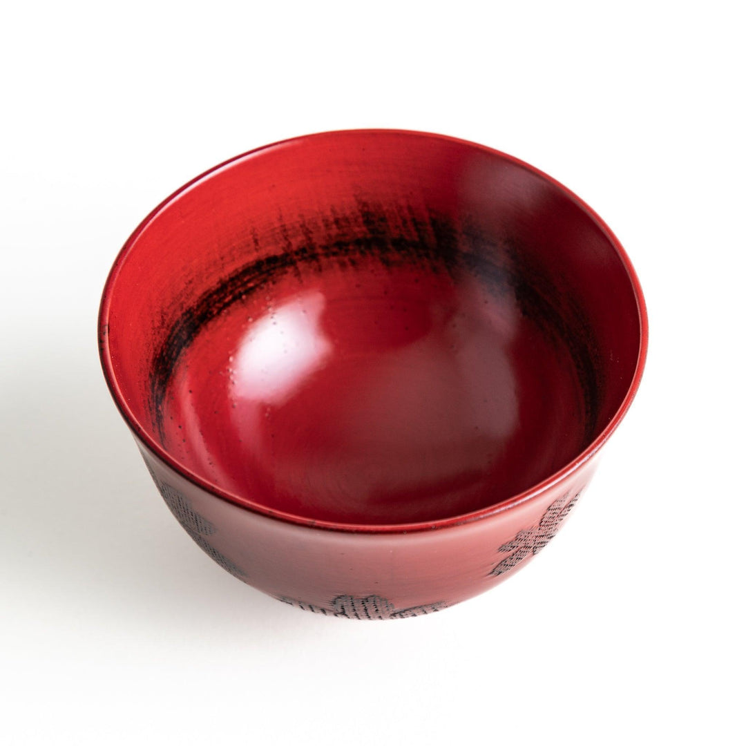 A lacquered bowl featuring a textured black floral design and a smooth, polished finish. Available in black or red.