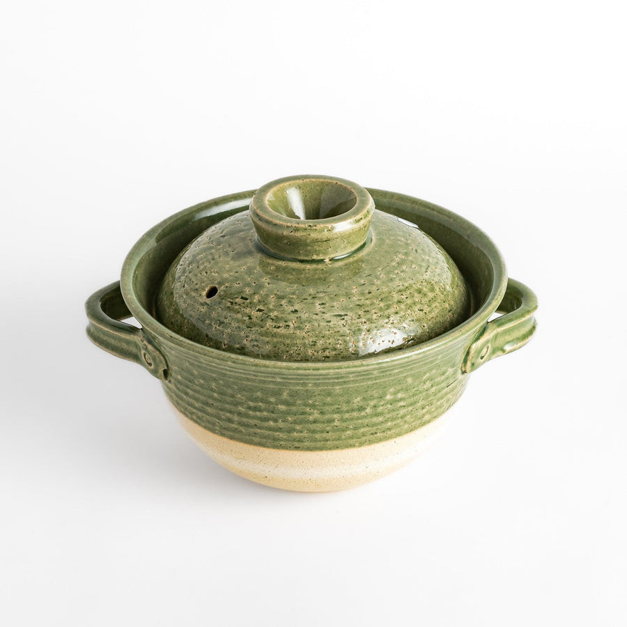 Emerald rice donabe clay pot with green glaze and round lid ideal for cooking flavorful Japanese rice.