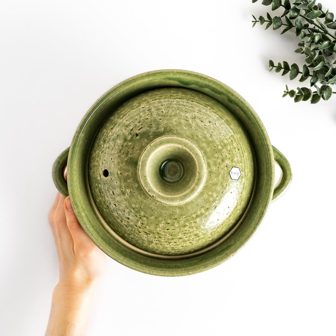 Emerald rice donabe clay pot with green glaze and round lid ideal for cooking flavorful Japanese rice.