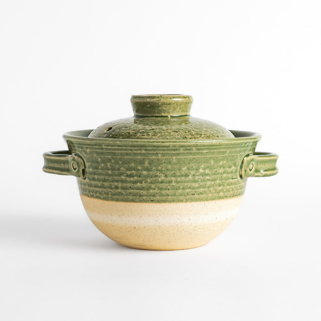 Emerald rice donabe clay pot with green glaze and round lid ideal for cooking flavorful Japanese rice.