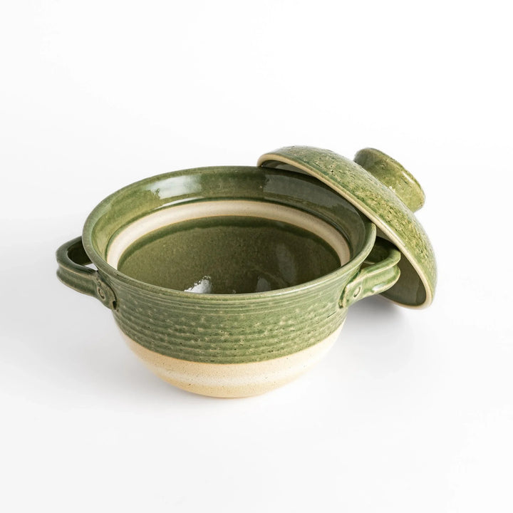 Emerald rice donabe clay pot with green glaze and round lid ideal for cooking flavorful Japanese rice.