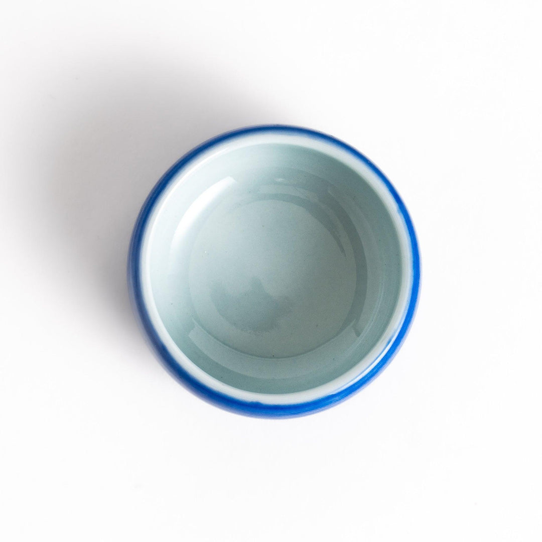 Ceramic condiment bowl with Japanese doll design perfect for serving sauces spices or small snacks.