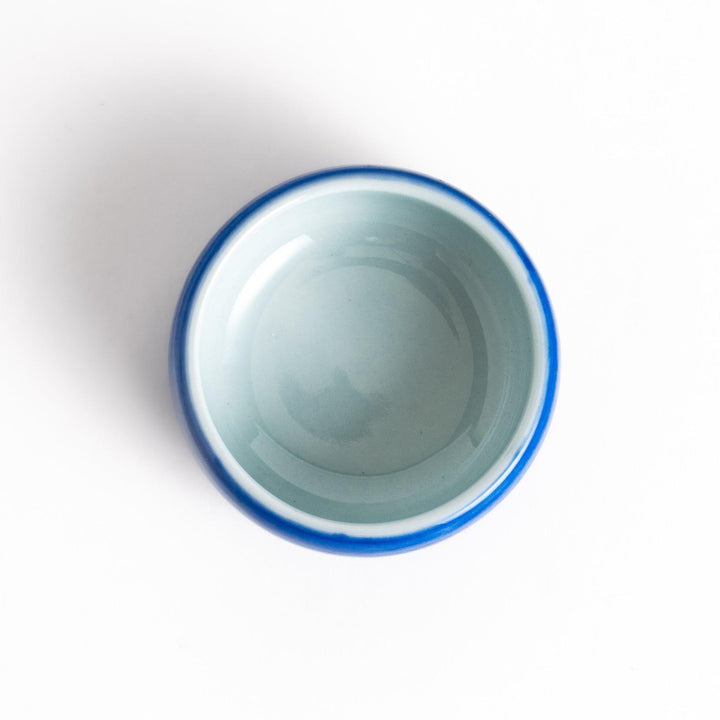 Ceramic condiment bowl with Japanese doll design perfect for serving sauces spices or small snacks.