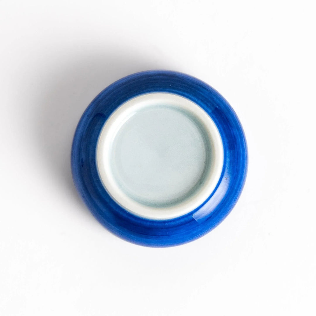 Ceramic condiment bowl with Japanese doll design perfect for serving sauces spices or small snacks.