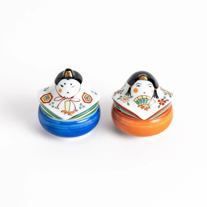 Pair of ceramic condiment bowls with Japanese doll designs adding festive charm to serving sauces or snacks.