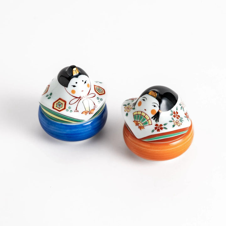 Pair of ceramic condiment bowls with Japanese doll designs adding festive charm to serving sauces or snacks.