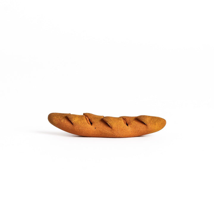 Epi bread shaped chopstick rest with warm brown glaze and detailed texture bringing bakery charm.