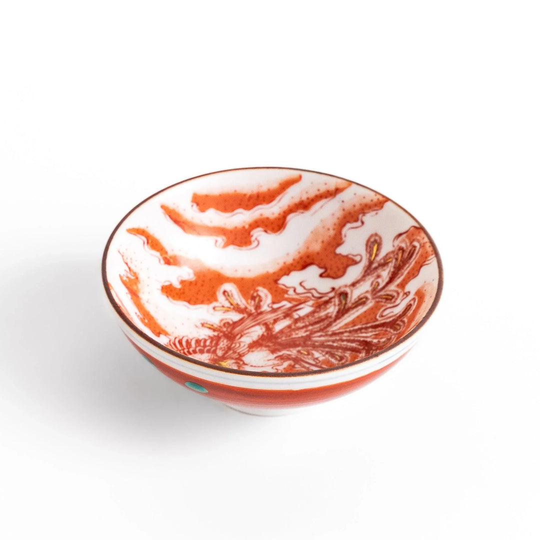 Delicate sake cup adorned with a red, accented by soft swirling clouds, creating a beautiful, traditional Japanese motif.