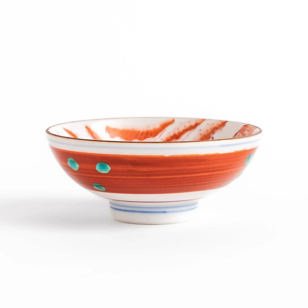 Delicate sake cup adorned with a red, accented by soft swirling clouds, creating a beautiful, traditional Japanese motif.