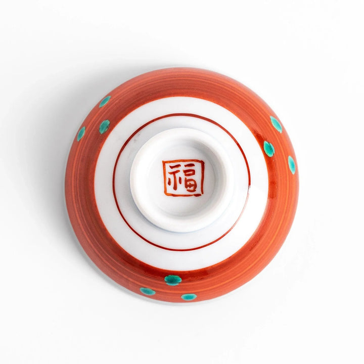 Delicate sake cup adorned with a red, accented by soft swirling clouds, creating a beautiful, traditional Japanese motif.