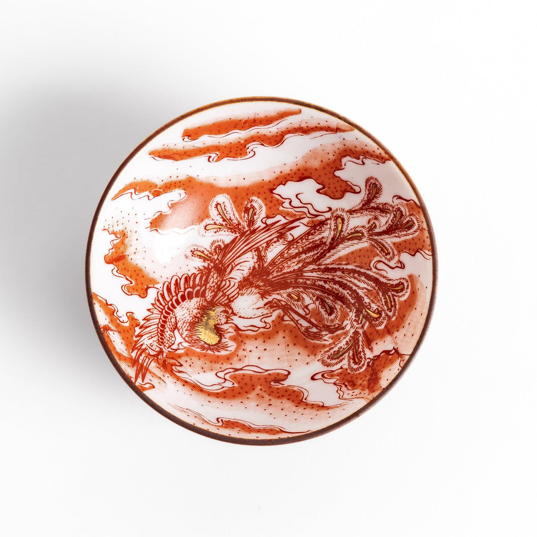 Delicate sake cup adorned with a red, accented by soft swirling clouds, creating a beautiful, traditional Japanese motif.