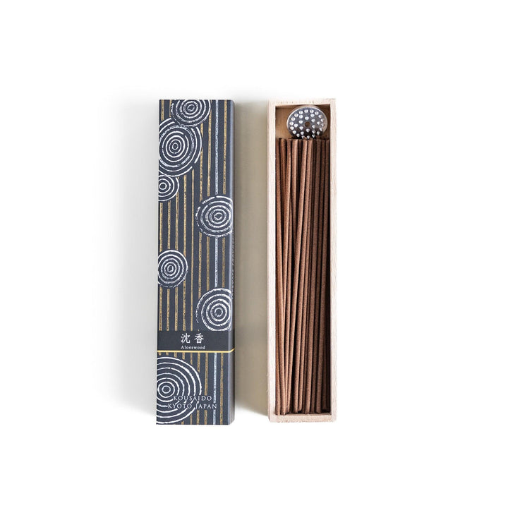 Japanese agarwood incense sticks in a wooden box with an elegant dark patterned sleeve from Kyoto’s Kousaido
