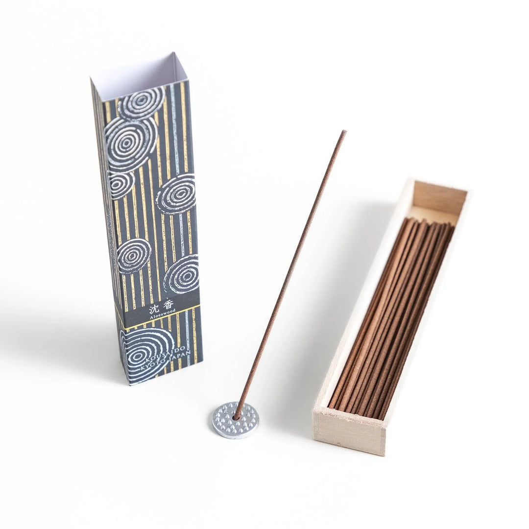 Japanese agarwood incense sticks in a wooden box with an elegant dark patterned sleeve from Kyoto’s Kousaido