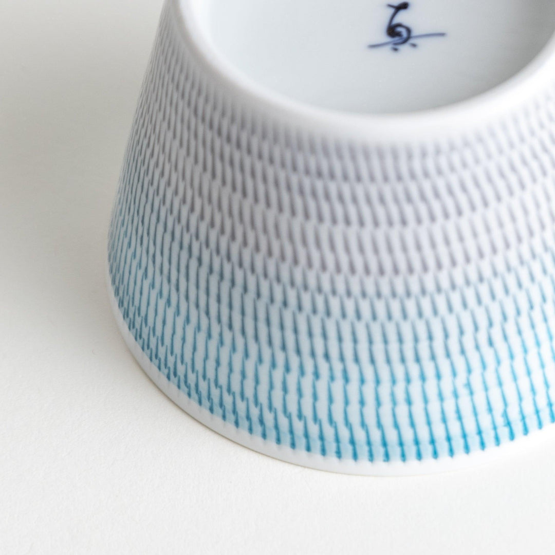 Japanese porcelain dessert bowl with delicate vertical line pattern and smooth gradient design for modern, everyday dining