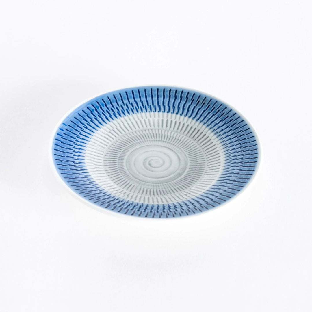 Blue dessert plate with vibrant spiral-striped patterns, viewed from a slight angle.
