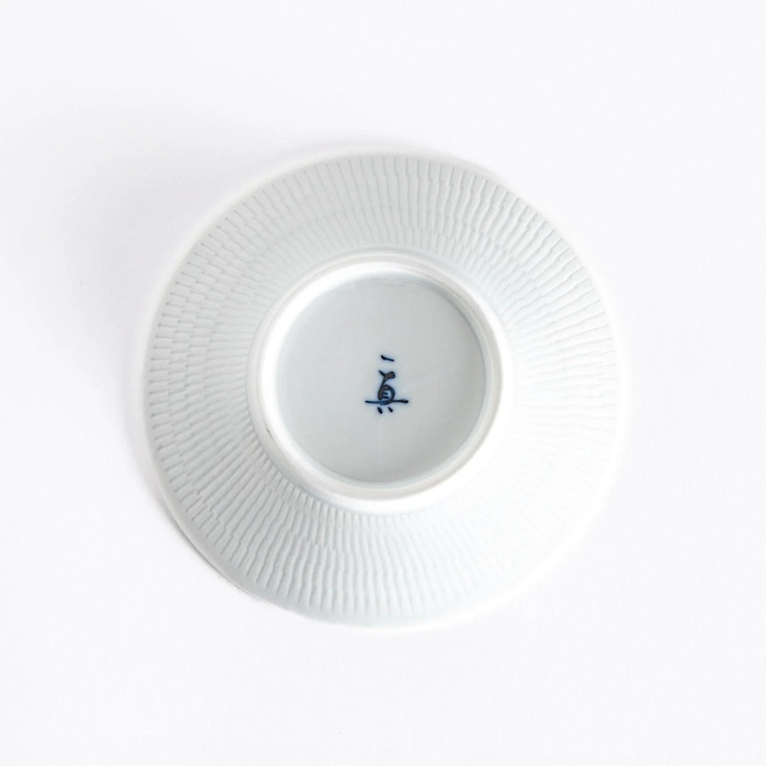 The bottom of the red dessert plate, showcasing its smooth white base and delicate finish.