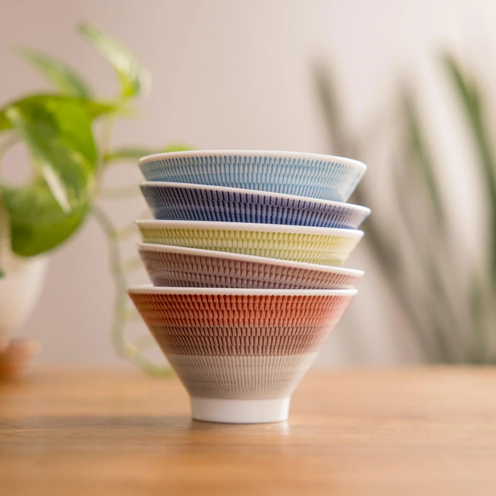 Colorful rice bowls featuring a unique ribbed design, perfect for serving rice or salads and adding a stylish touch to meals.
