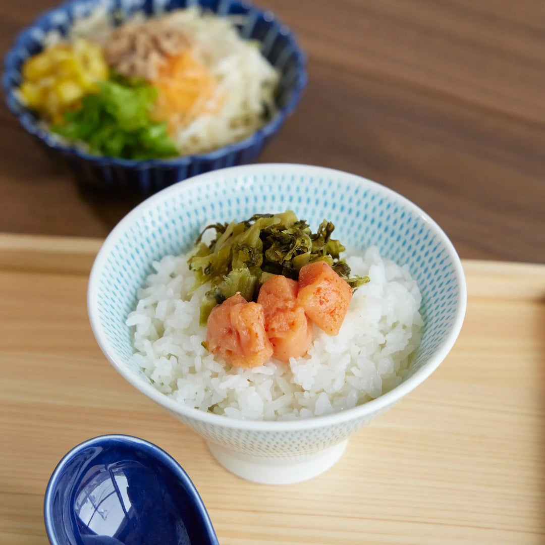 Ethereal Stripe Mount Fuji Rice Bowl filled with white rice, topped with mentaiko and pickled greens, set on a wooden tray.