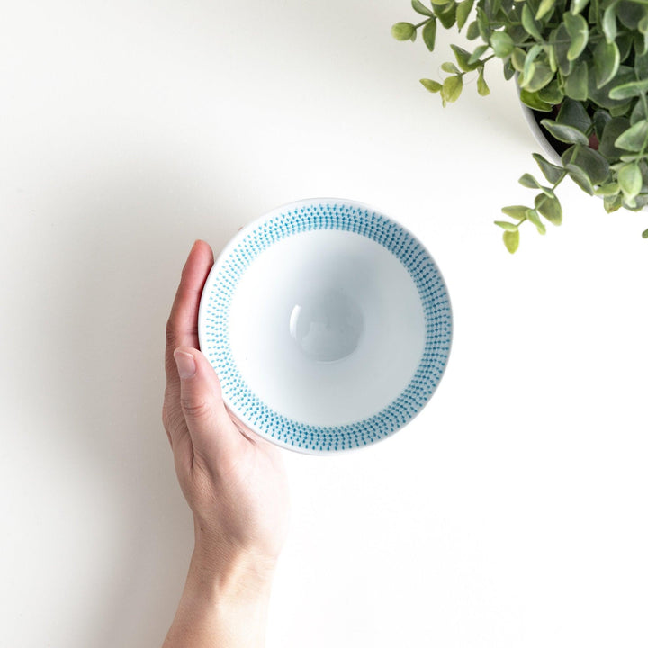 Colorful rice bowls with a gradient texture in various shades including green, blue, red, and brown.