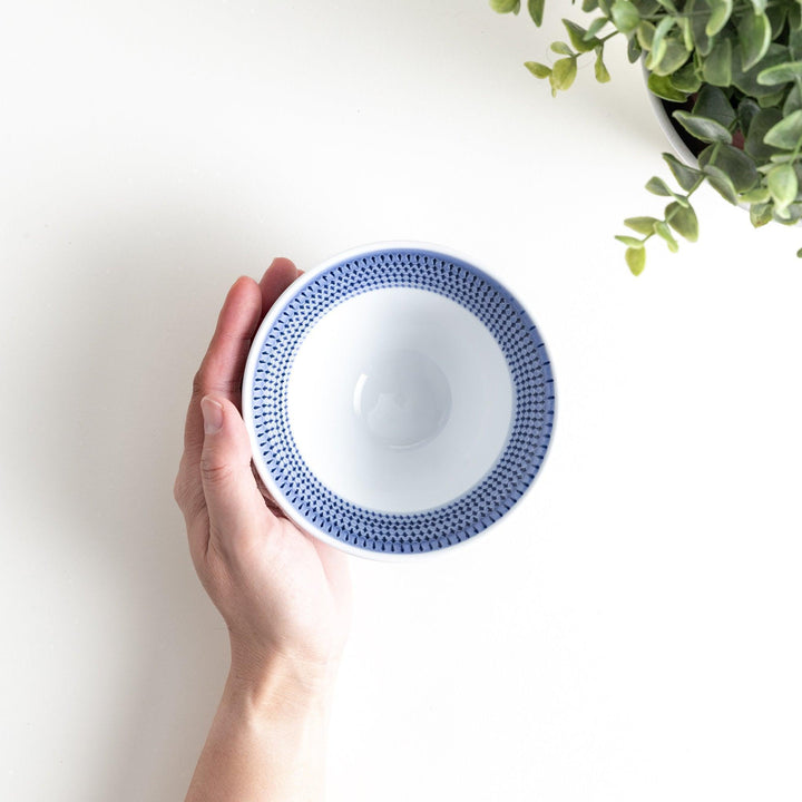 Colorful rice bowls with a gradient texture in various shades including green, blue, red, and brown.