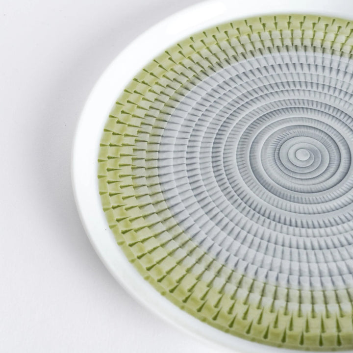 Close-up of the intricate light green spiral pattern, radiating outwards with fine detail.