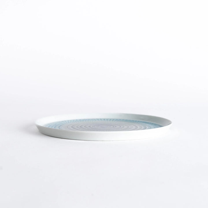 Side view of the plate, showcasing its sleek profile and the vibrant light blue spiral design.