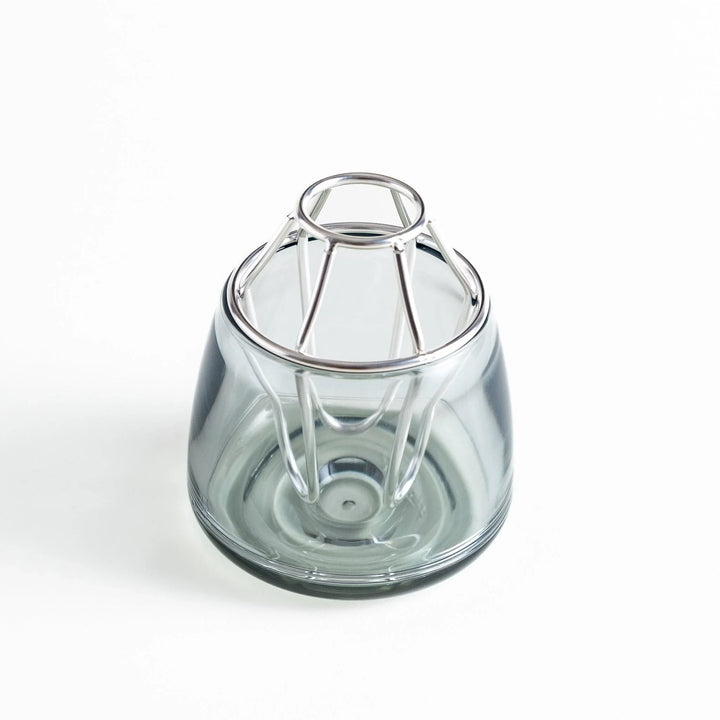 Glass vase with a silver-colored frame on top. The frame has a unique geometric design.