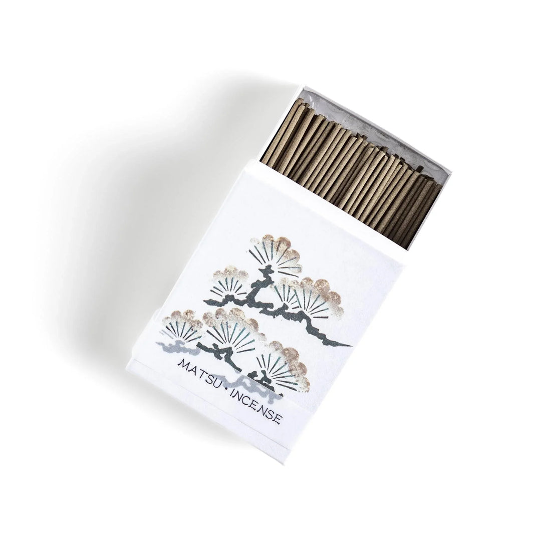 Incense with brown sticks in a pine tree design box offering a fresh woody fragrance reminiscent of evergreen forests.