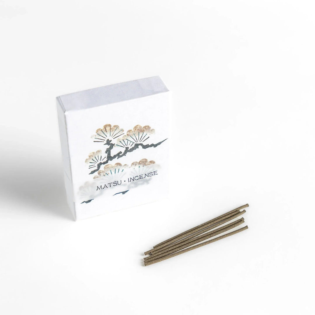 Incense with brown sticks in a pine tree design box offering a fresh woody fragrance reminiscent of evergreen forests.