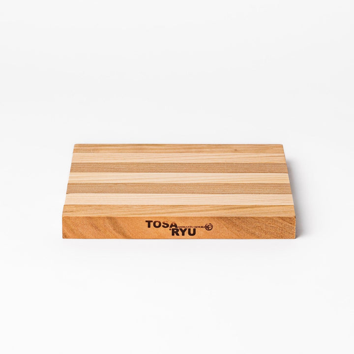 Expandable hinoki and cherry wood trivet with slats fanned out, showing mixed wood tones for versatile pot support