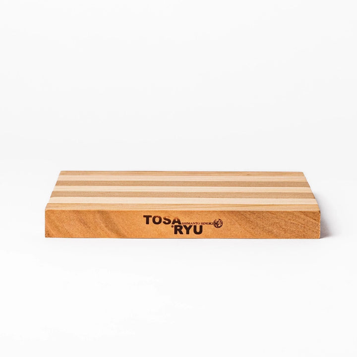 Expandable hinoki and cherry wood trivet with slats fanned out, showing mixed wood tones for versatile pot support