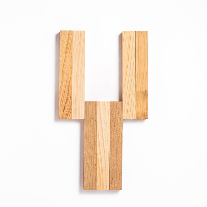 Expandable hinoki and cherry wood trivet with slats fanned out, showing mixed wood tones for versatile pot support