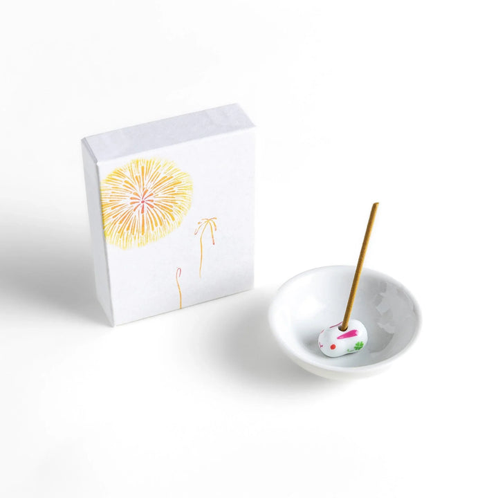 Golden incense sticks in fireworks motif box offering a bright uplifting fragrance for festive occasions.