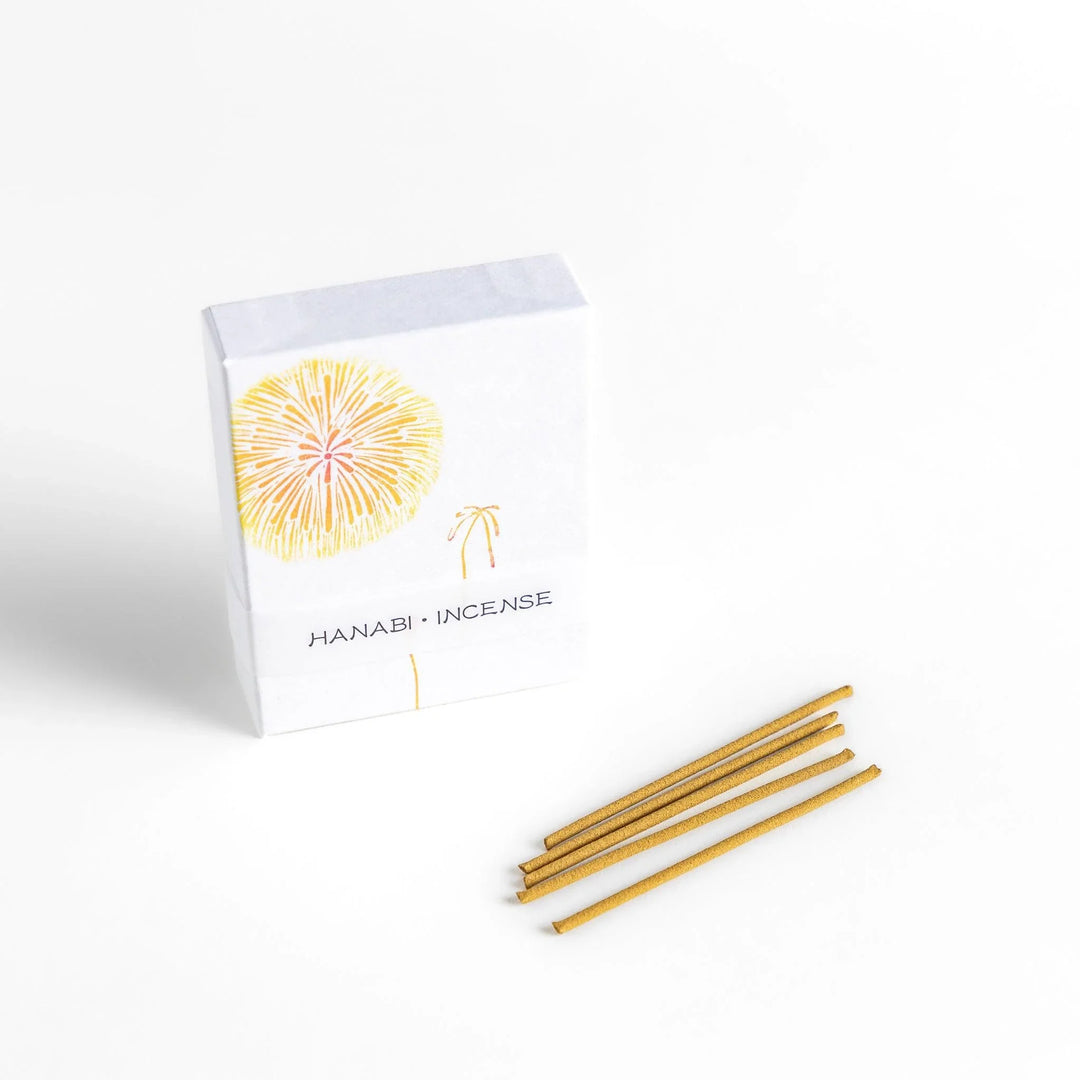 Golden incense sticks in fireworks motif box offering a bright uplifting fragrance for festive occasions.