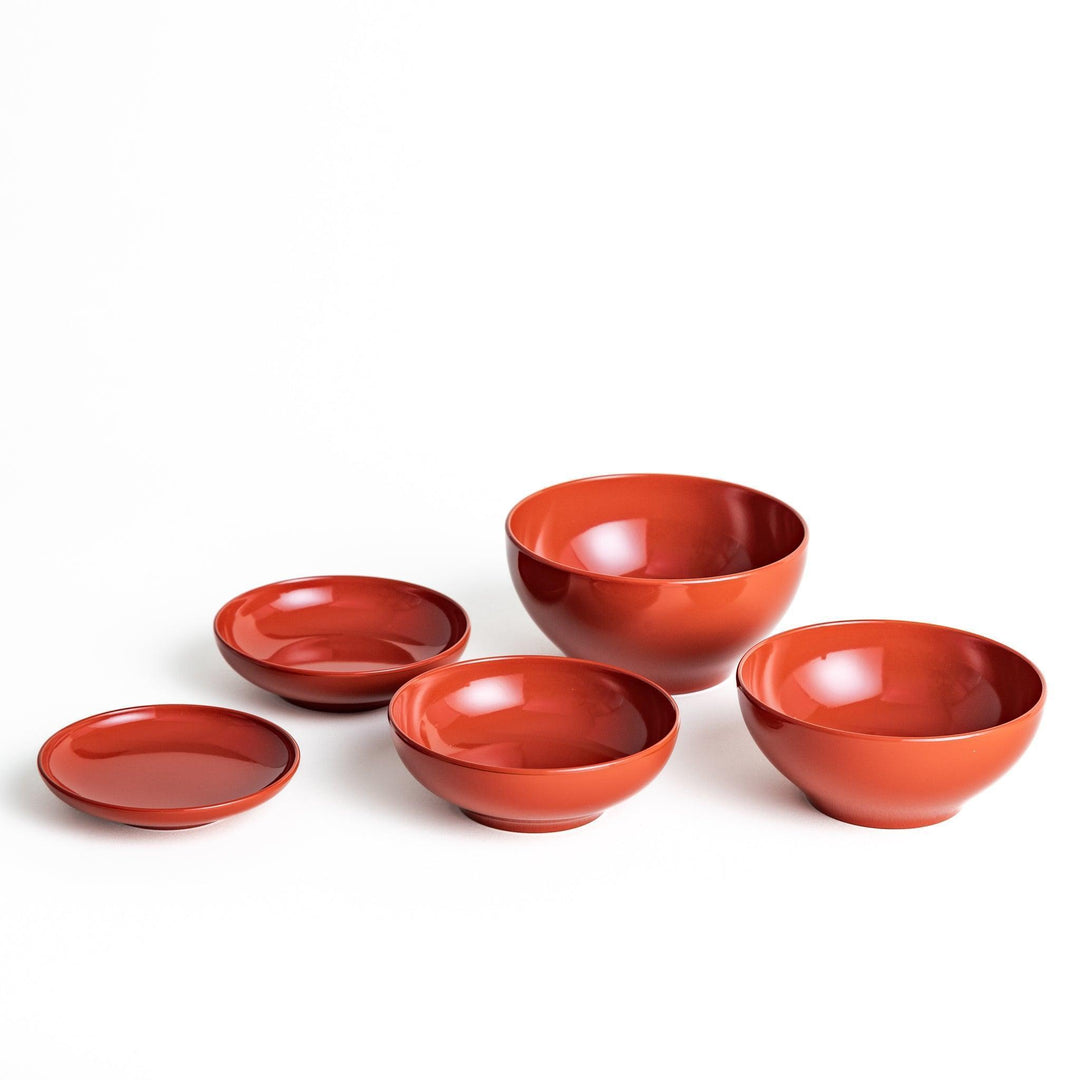 Set of five nested lacquer bowls used in Japanese oryoki meals representing minimalism mindfulness in black or red.