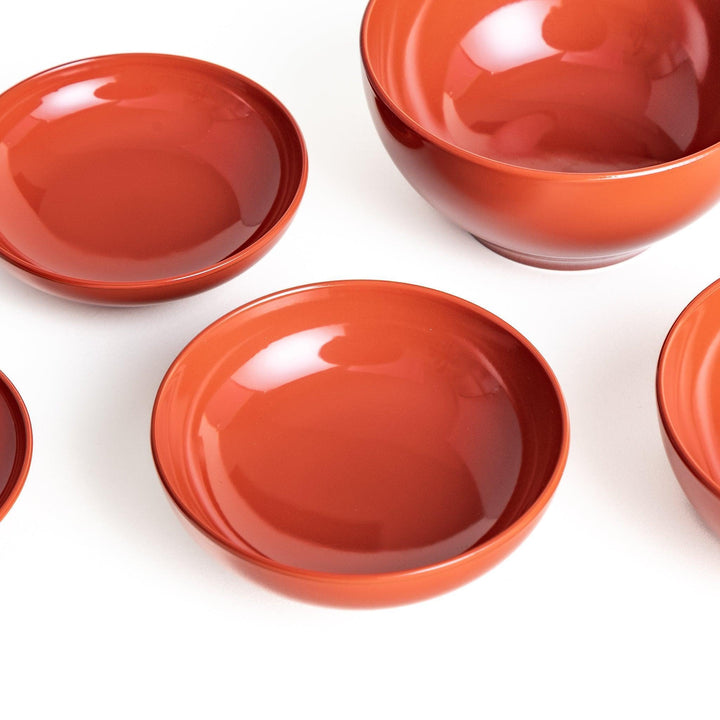 Set of five nested lacquer bowls used in Japanese oryoki meals representing minimalism mindfulness in black or red.