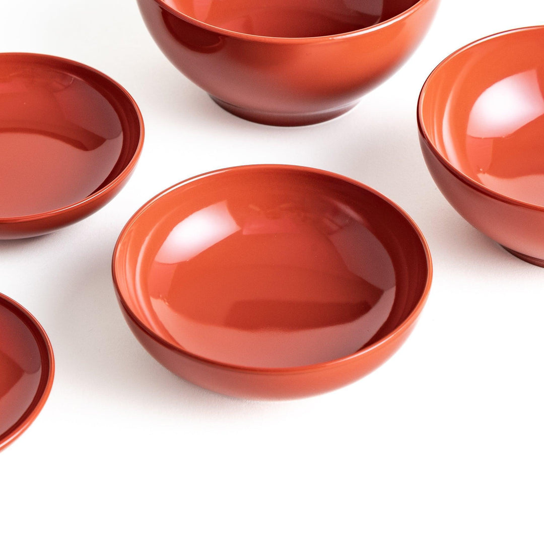 Set of five nested lacquer bowls used in Japanese oryoki meals representing minimalism mindfulness in black or red.