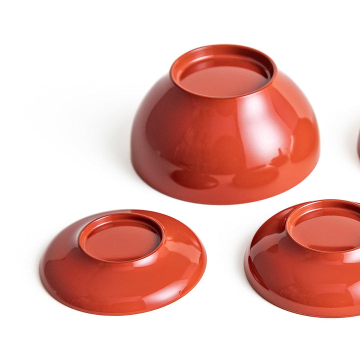 Set of five nested lacquer bowls used in Japanese oryoki meals representing minimalism mindfulness in black or red.