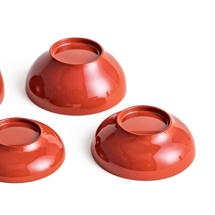 Set of five nested lacquer bowls used in Japanese oryoki meals representing minimalism mindfulness in black or red.