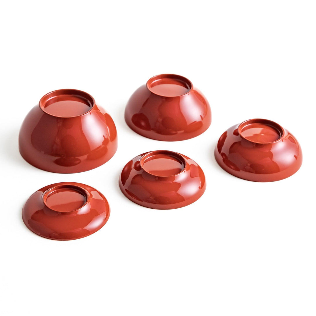 Set of five nested lacquer bowls used in Japanese oryoki meals representing minimalism mindfulness in black or red.