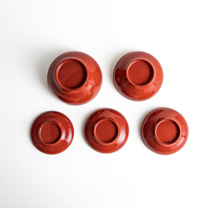 Set of five nested lacquer bowls used in Japanese oryoki meals representing minimalism mindfulness in black or red.