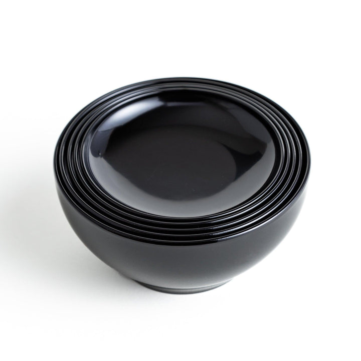 Set of five nested lacquer bowls used in Japanese oryoki meals representing minimalism mindfulness in black or red.