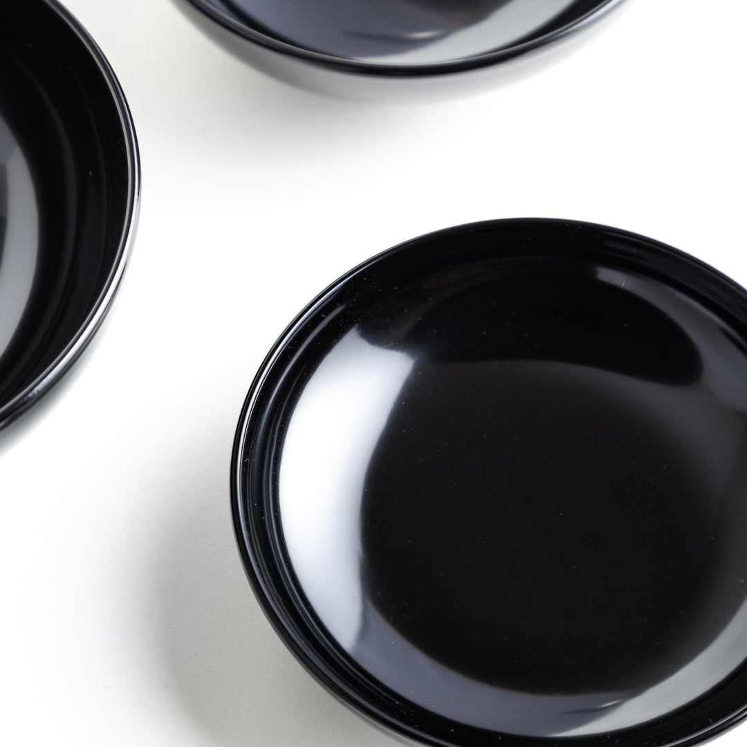 Set of five nested lacquer bowls used in Japanese oryoki meals representing minimalism mindfulness in black or red.