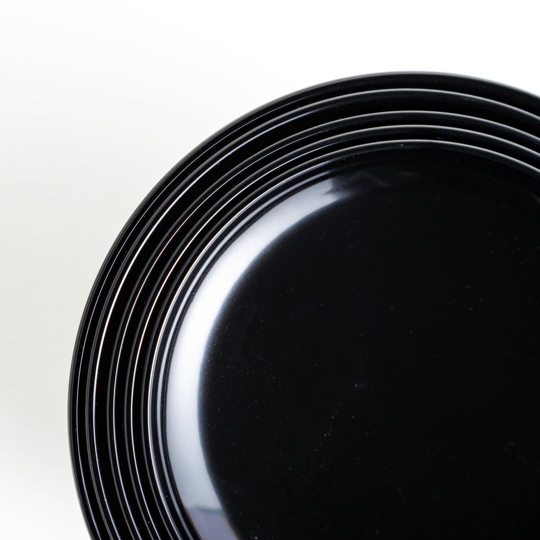 Set of five nested lacquer bowls used in Japanese oryoki meals representing minimalism mindfulness in black or red.