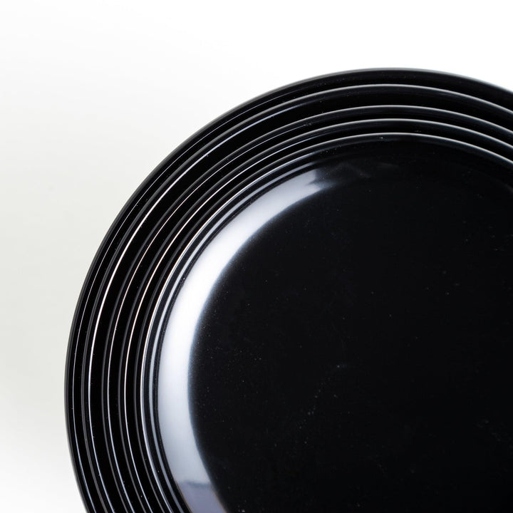 Set of five nested lacquer bowls used in Japanese oryoki meals representing minimalism mindfulness in black or red.