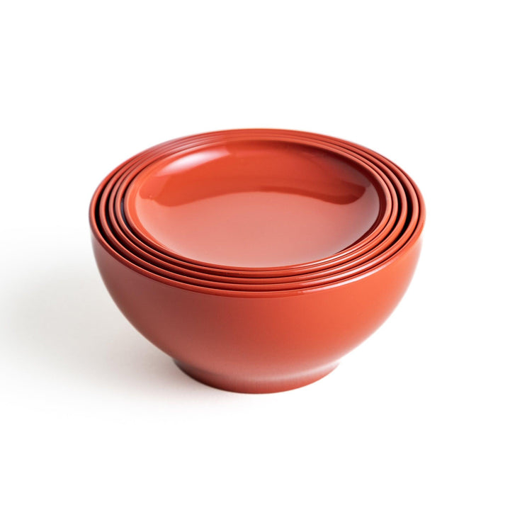 Set of five nested lacquer bowls used in Japanese oryoki meals representing minimalism mindfulness in black or red.