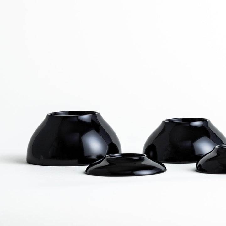 Set of five nested lacquer bowls used in Japanese oryoki meals representing minimalism mindfulness in black or red.