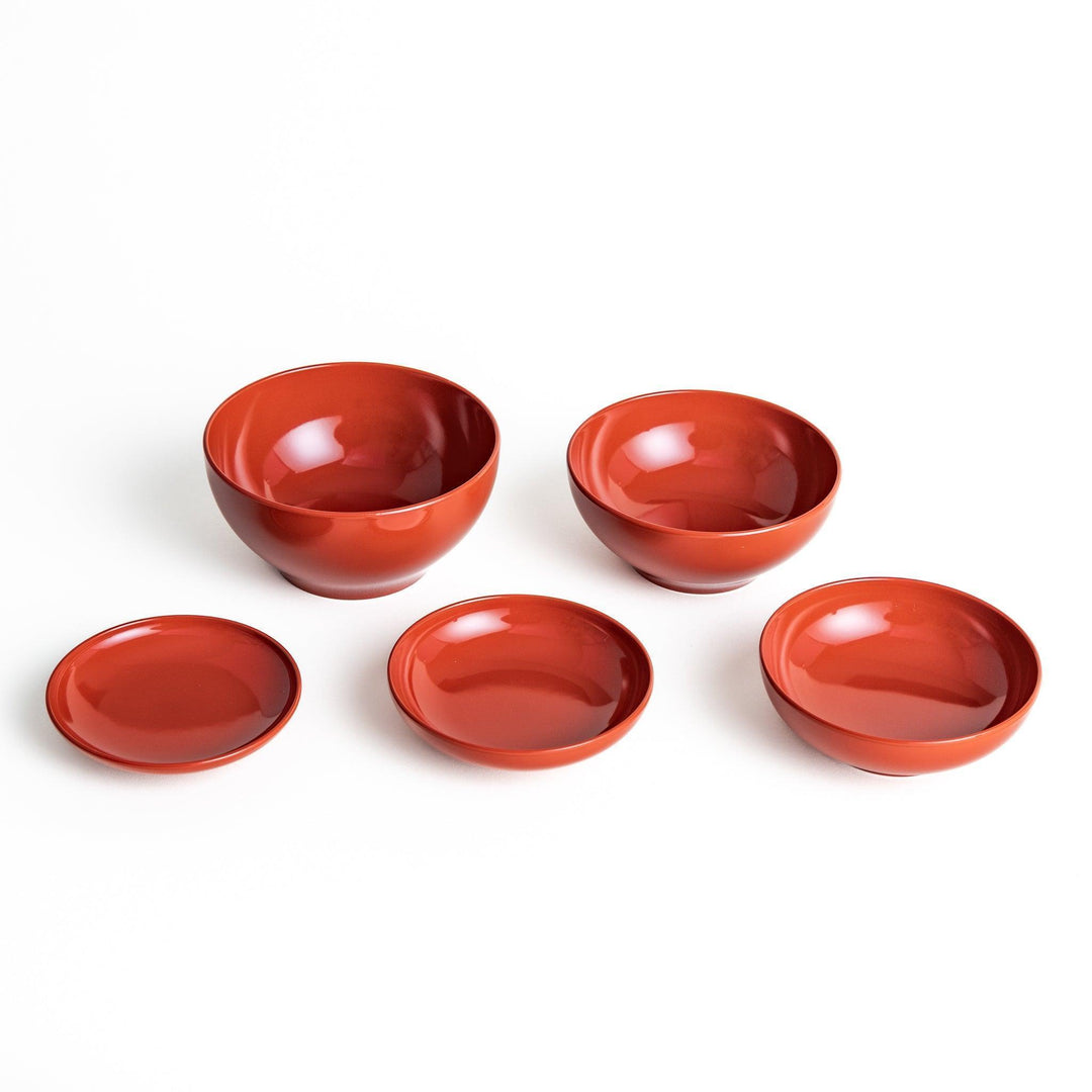 Set of five nested lacquer bowls used in Japanese oryoki meals representing minimalism mindfulness in black or red.