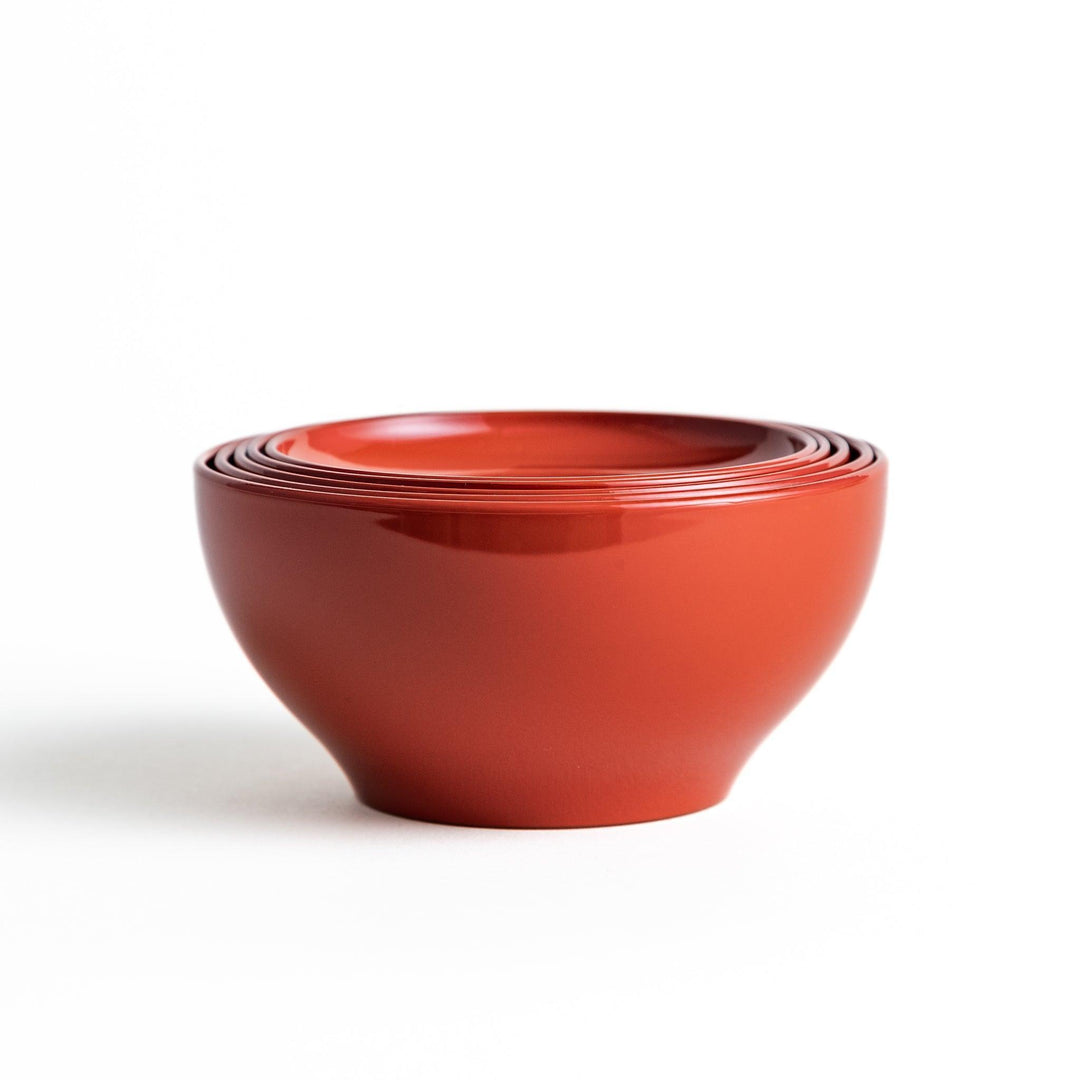 Set of five nested lacquer bowls used in Japanese oryoki meals representing minimalism mindfulness in black or red.