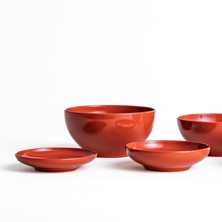 Set of five nested lacquer bowls used in Japanese oryoki meals representing minimalism mindfulness in black or red.